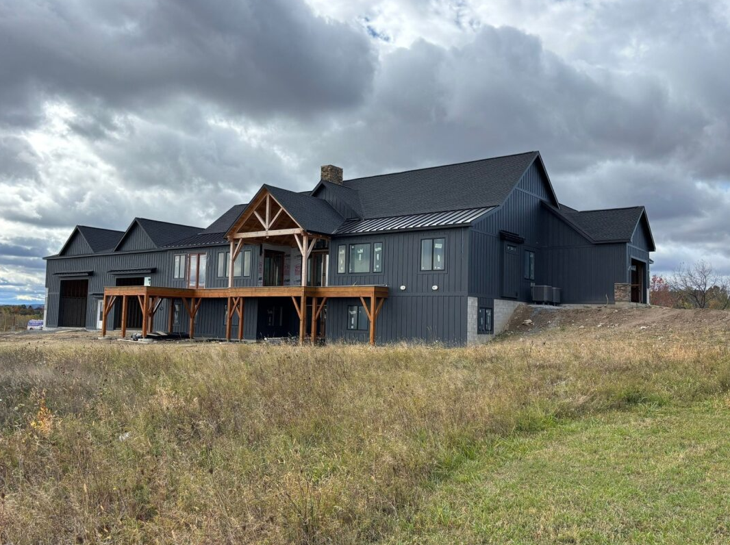 Two-story houses with white and gray exteriors, two car garages, and well-maintained landscaping under a blue sky. Two-story houses with white and gray exteriors, two car garages, and well-maintained landscaping under a blue sky.