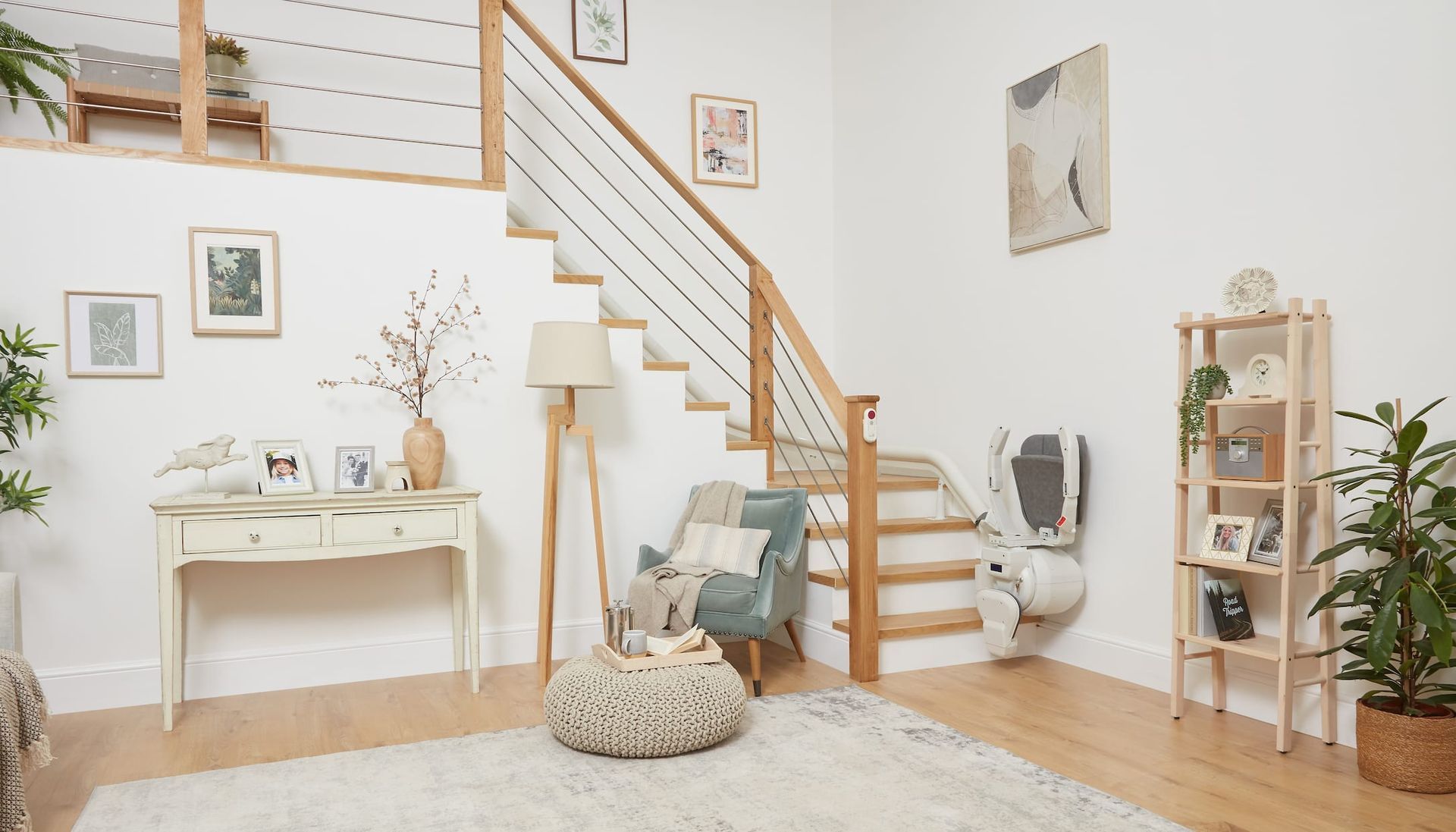 Interior with a wooden staircase, plants, and neutral-toned furniture. A cozy living space with natural light.