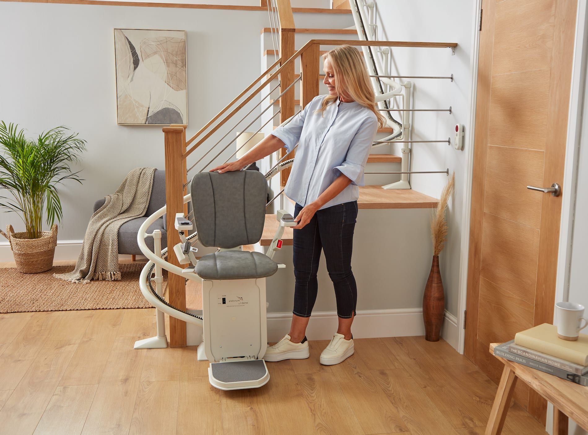 Woman using a stair lift in a bright home interior