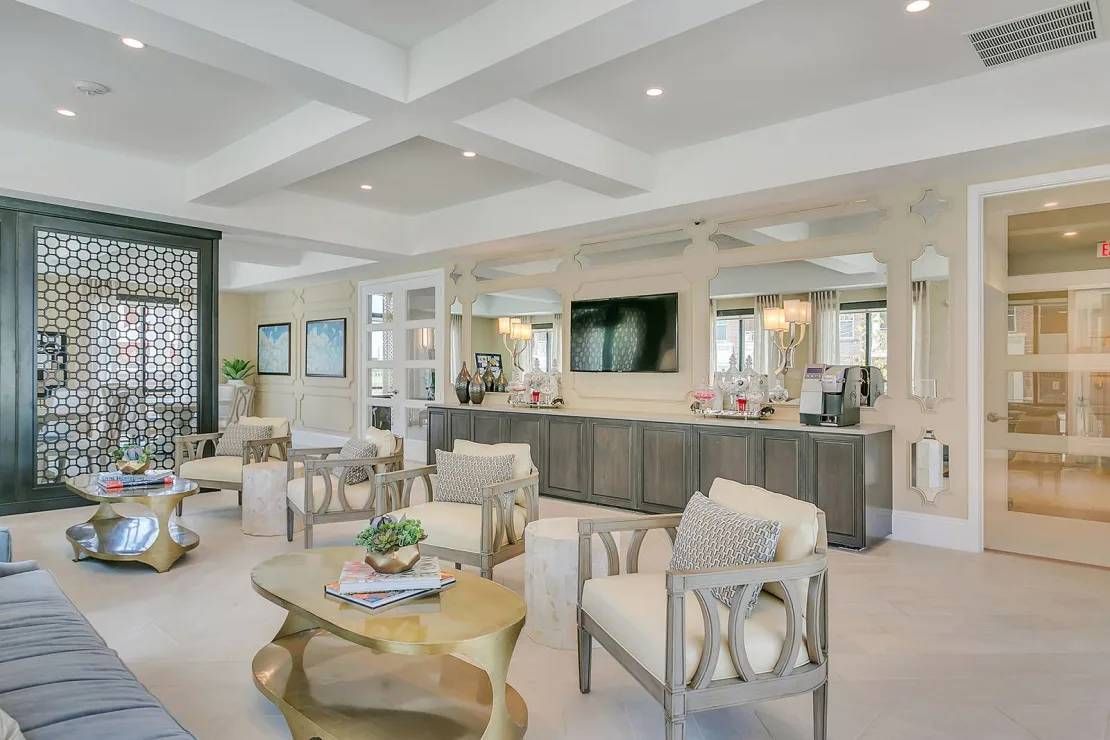 Bright modern lounge with sofas, coffee tables, and a central reception counter