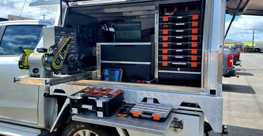 A Truck With A Toolbox In The Back Is Parked In A Parking Lot — Troy Cummings Locksmith In Bungalow, QLD