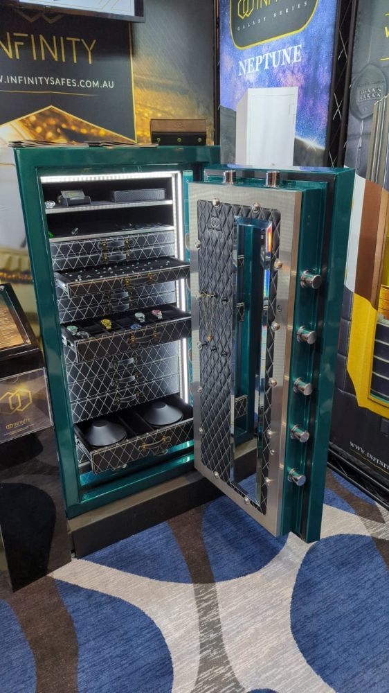 A Green Safe With The Door Open Is Sitting On Top Of A Blue And White Rug — Troy Cummings Locksmith In Bungalow, QLD