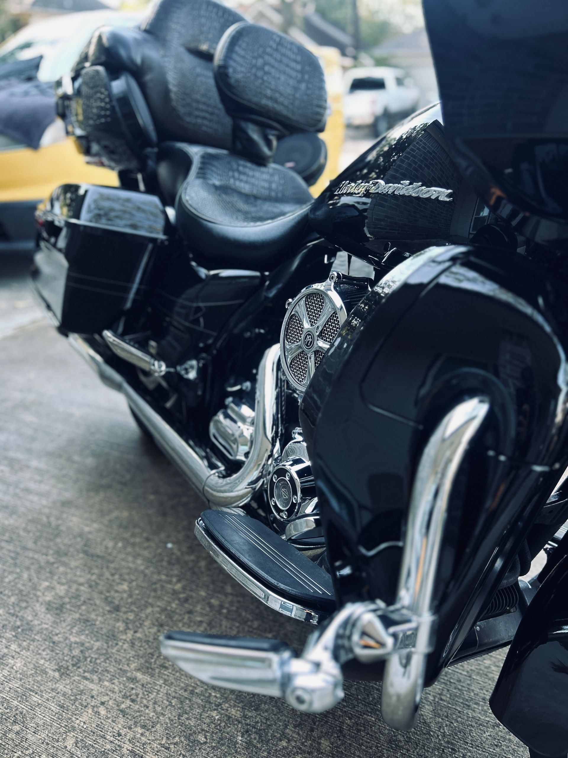 Black Harley-Davidson motorcycle with chrome accents parked on a concrete surface.