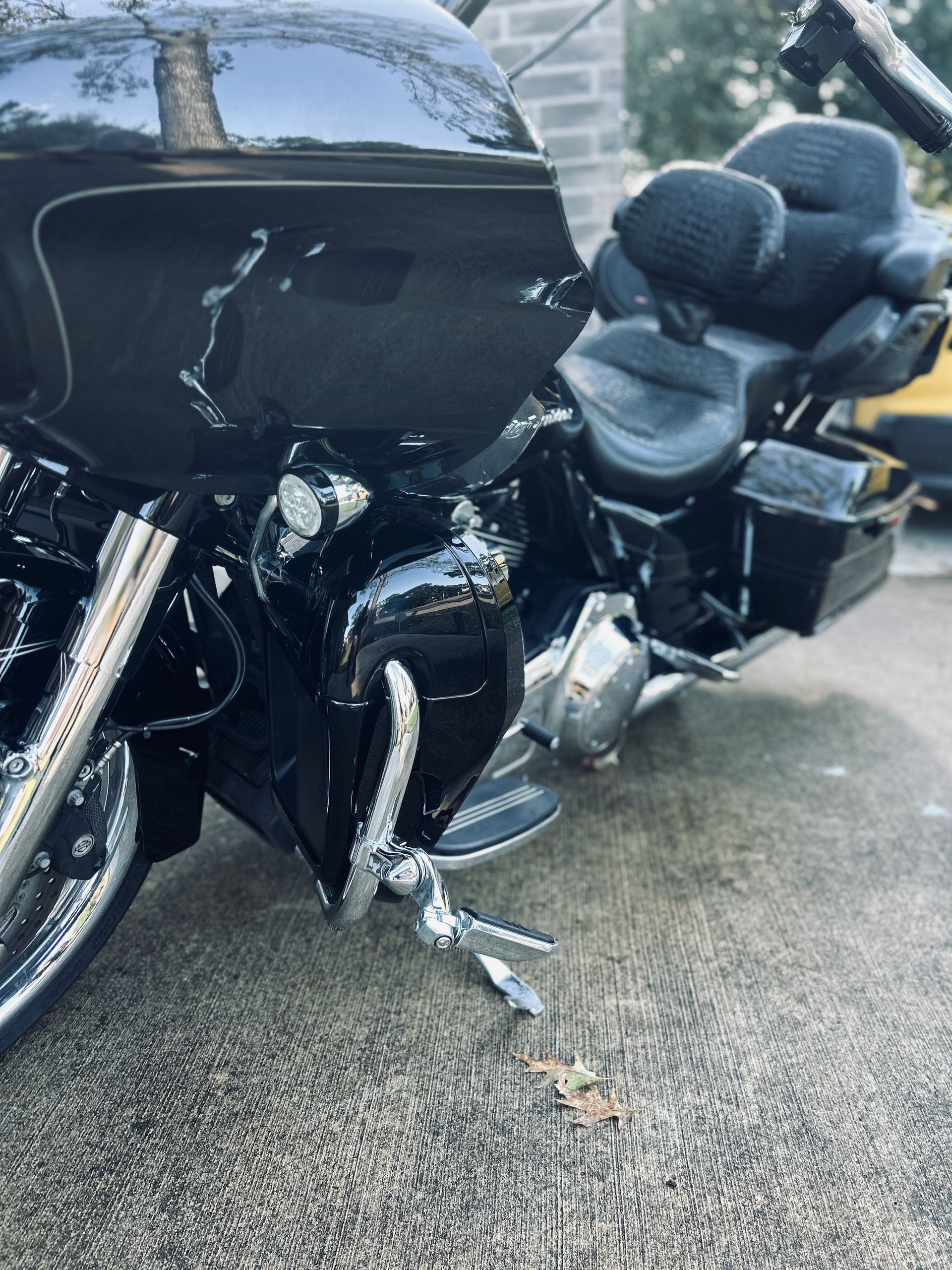 Black motorcycle with chrome accents parked on a paved surface.