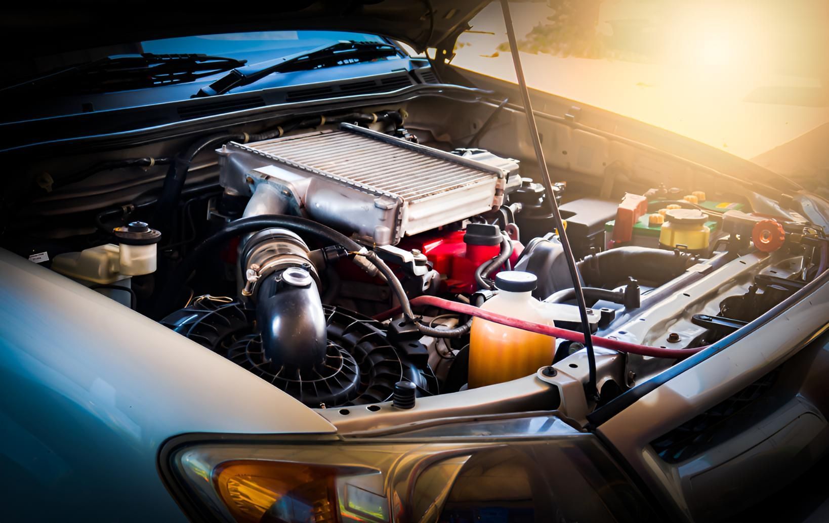 The Engine of a Car is Shown With the Hood Open — Cessnock Batteries In Bellbird, NSW