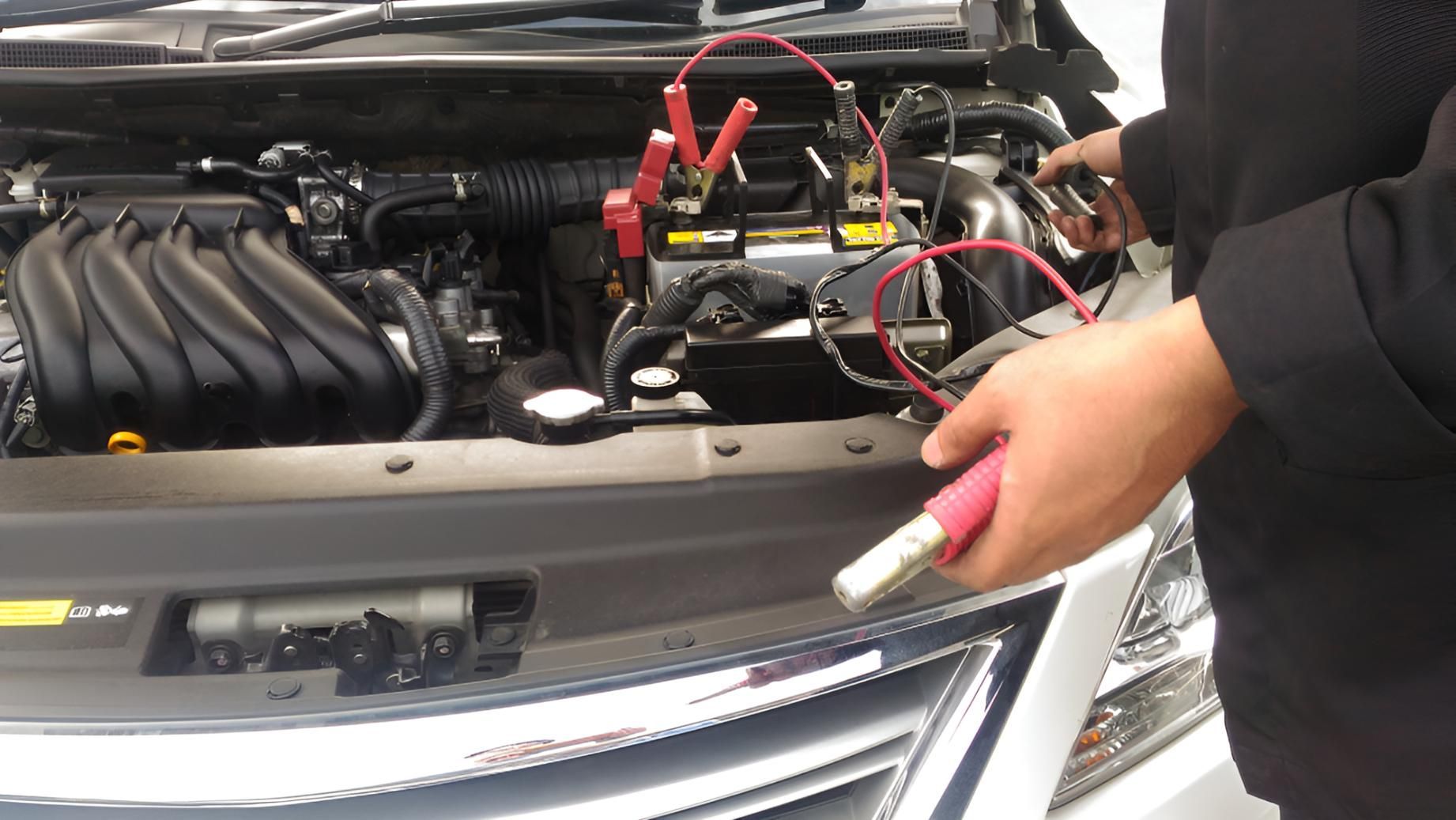 A Person is Charging a Car Battery With a Charger — Cessnock Batteries In Kurri Kurri, NSW