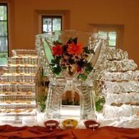 Glassware display with floral centerpiece on a table, set against a warm indoor background