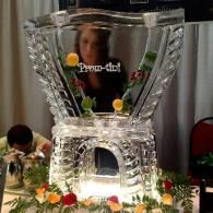 Clear ice decorative vase centerpiece with flowers at an event table