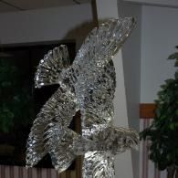 Abstract metallic sculpture in an indoor lobby, made of reflective silver pieces