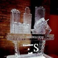 Milwaukee crystal trophy with city skyline and names Heather and Jeff on a dark wood shelf