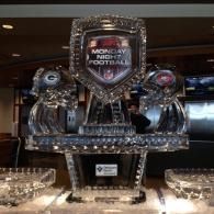 Ice sculpture with central plaque reading “Monday Night Football,” displayed on a table.