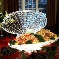 Elegant plated buffet dish with a decorative fan of silverware on a banquet table