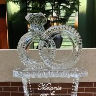 Crystal interlocking rings display on a clear stand with a personalized nameplate indoors