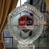 Crystal trophy plaque reading “RFCT Farrell Cup 2017” on a table by a window