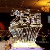 Crystal “25” anniversary ice sculpture on a lit banquet table in a banquet hall