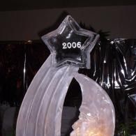 Silver arch decoration topped with a black star labeled “2006” against a dark background