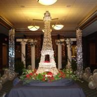 Decorative Eiffel Tower centerpiece with flowers and balloons in a banquet hall