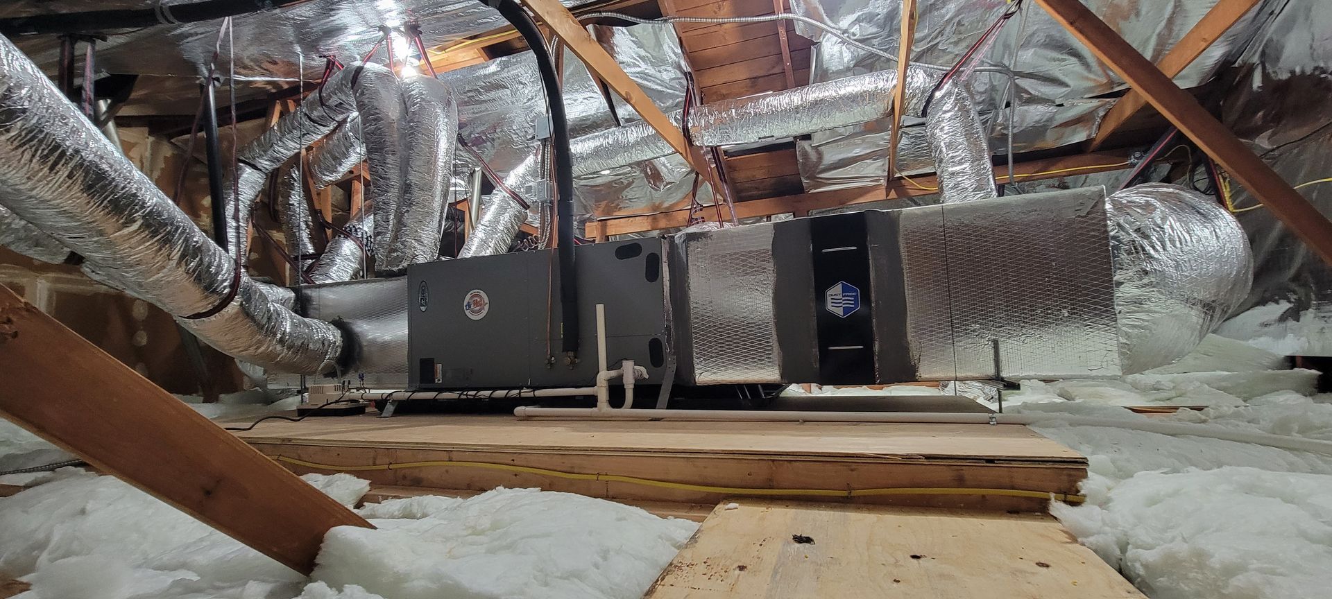 There is a ventilation system in the attic of a house.