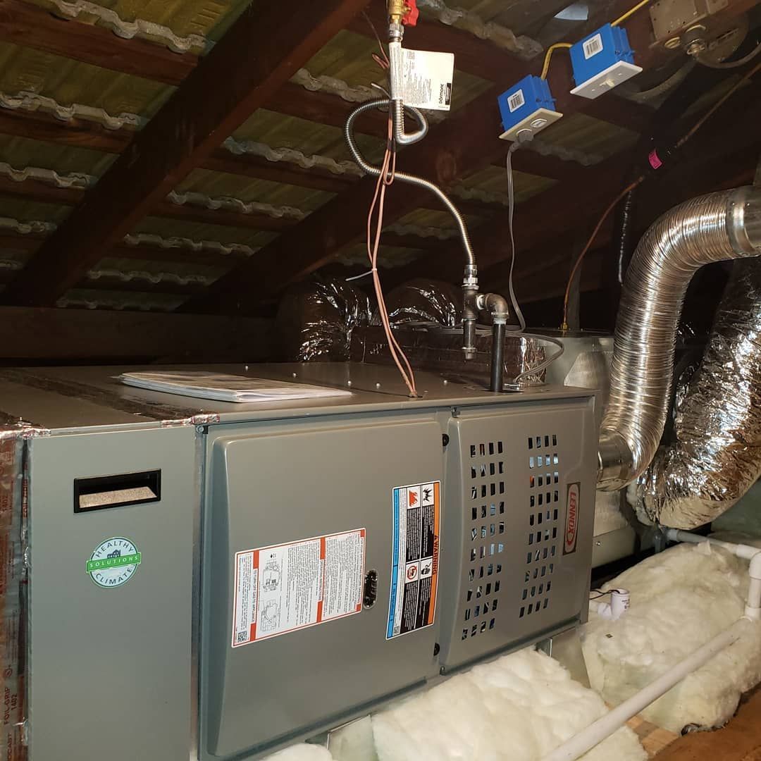 An air conditioner is sitting in the attic of a house