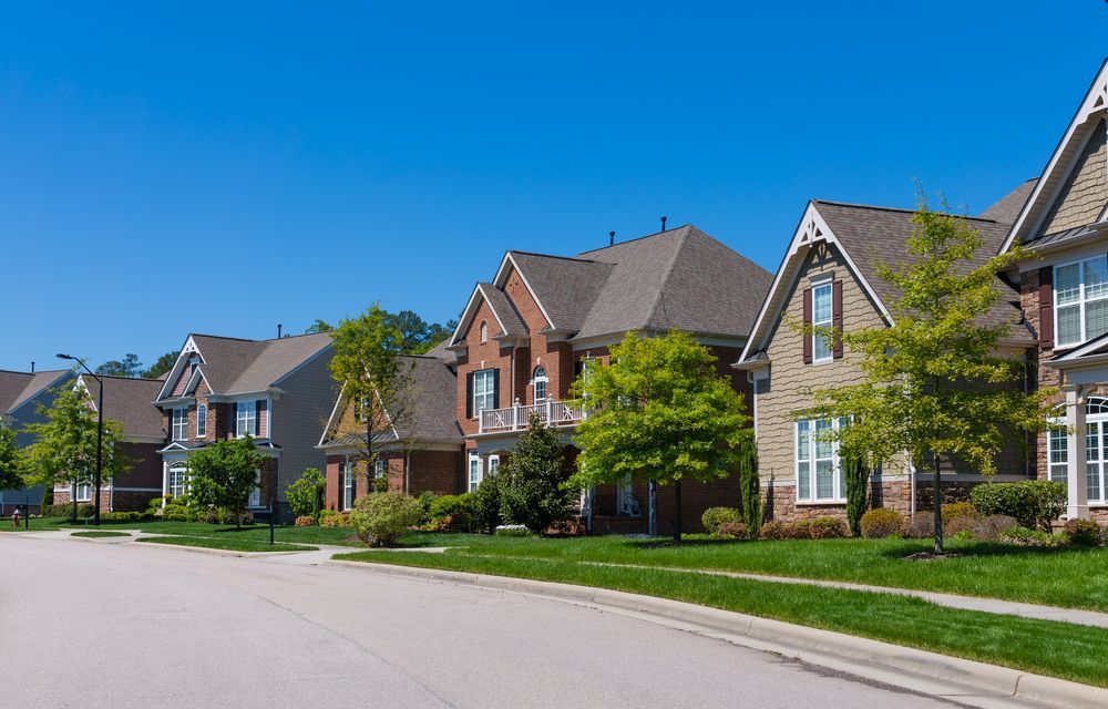 Row of Houses With Brick and Siding, Green Lawns — Boland Contracting In Wellington, NSW