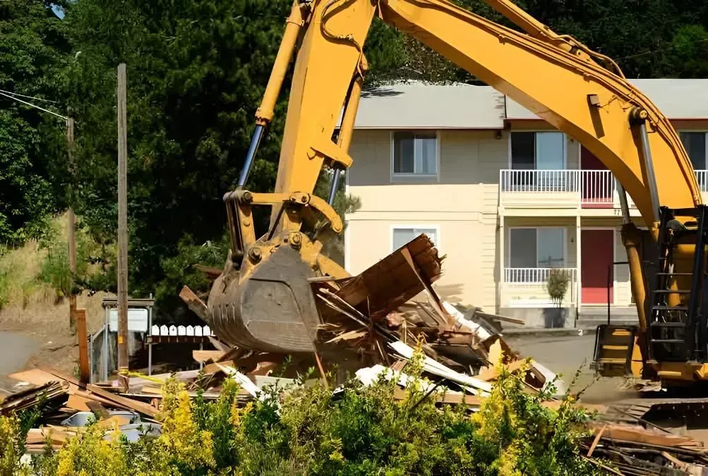 Yellow Excavator Demolishing a Building — Boland Contracting In Wellington, NSW