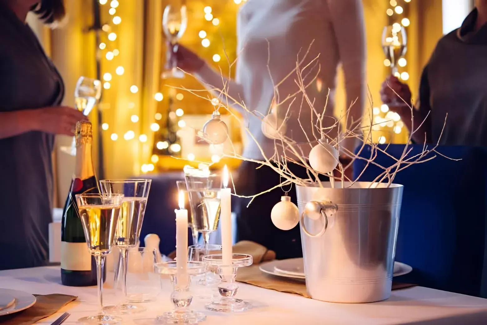 People Toasting With Champagne at a Festive Gathering With a Decorated Table — Boland Contracting In Wellington, NSW
