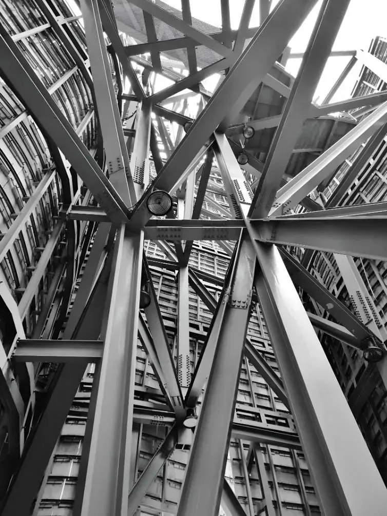 Black and White Photo Looking Up at the Complex Steel Structure of a Skyscraper — Boland Contracting In Wellington, NSW