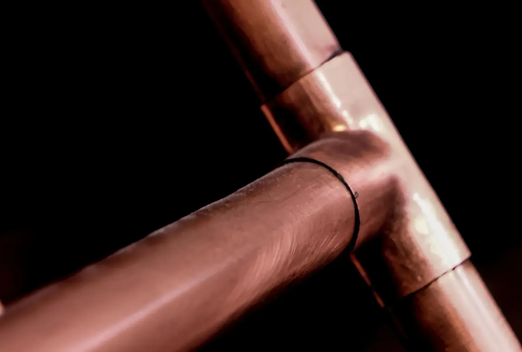 Close-Up Copper Pipes Joined With Fittings — Boland Contracting In Wellington, NSW