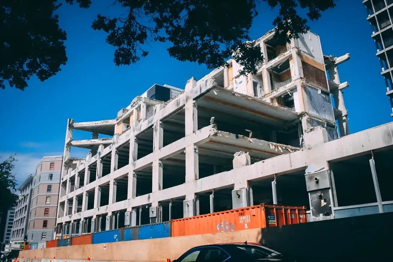 Demolished Multi-Story Building With Exposed Concrete Frame and Blue Sky — Boland Contracting In Wellington, NSW