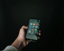 Hand holding smartphone with social media apps — digital marketing tools on mobile