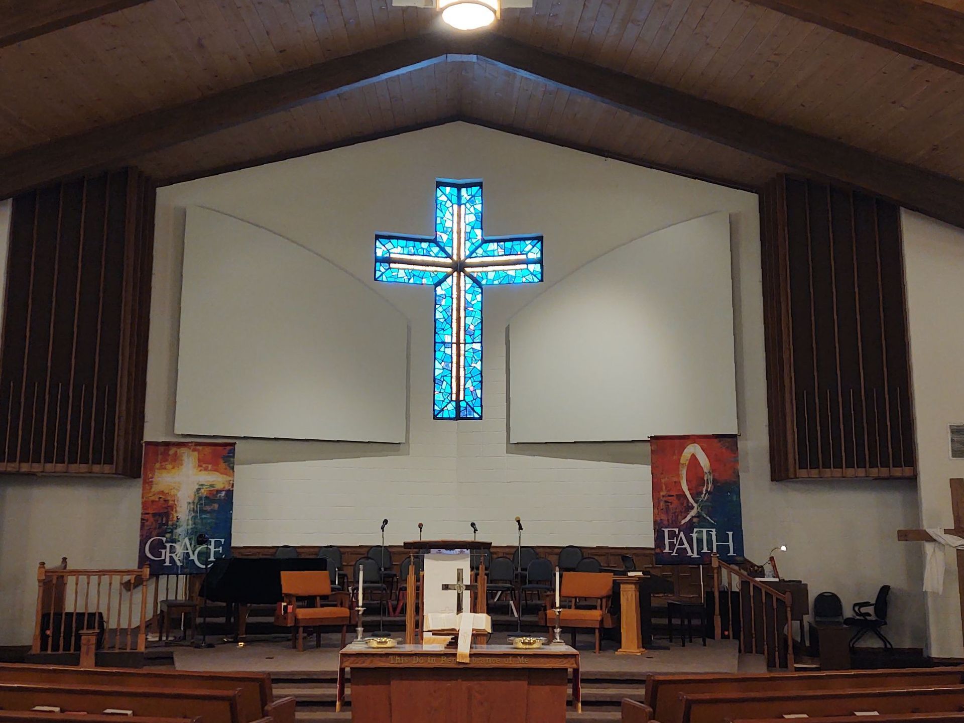 a church with a stained glass cross on the wall