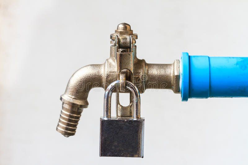 A close up of a faucet with a padlock attached to it.