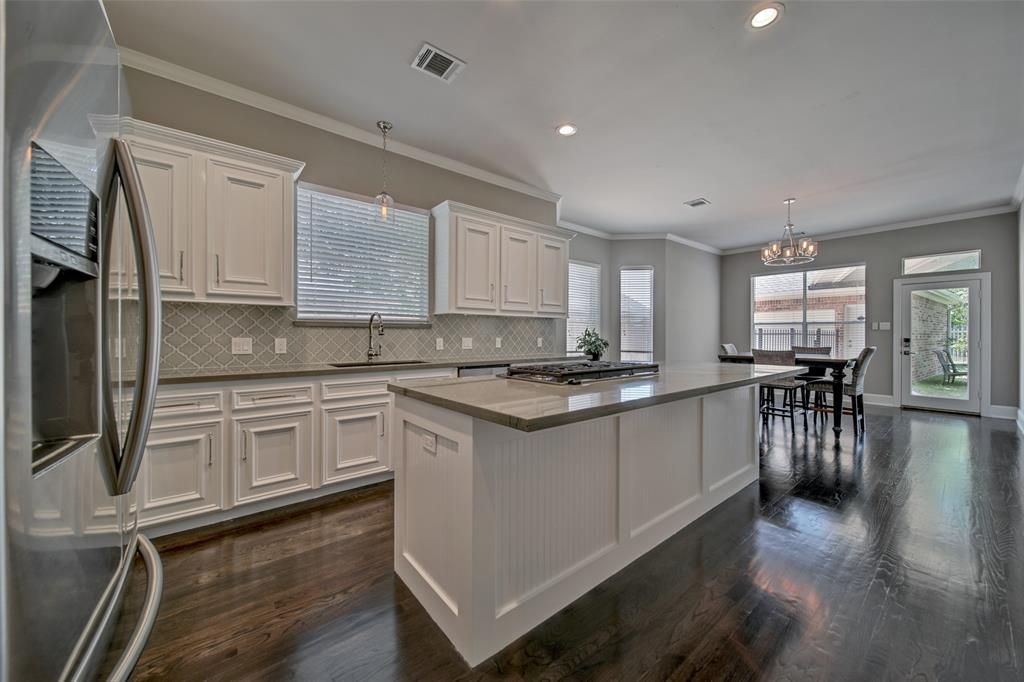 There is a large island in the middle of the kitchen.