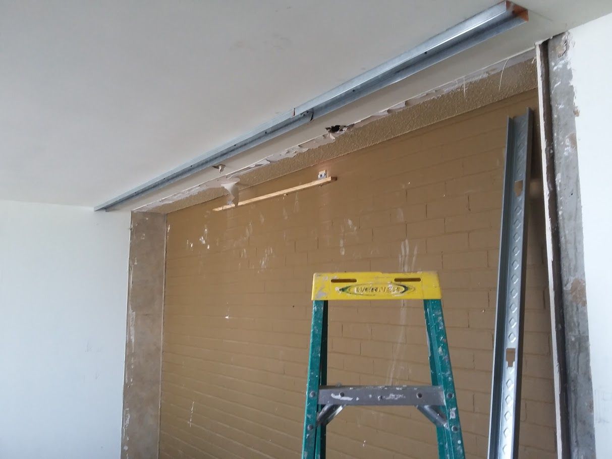 A yellow ladder is sitting in front of a wall