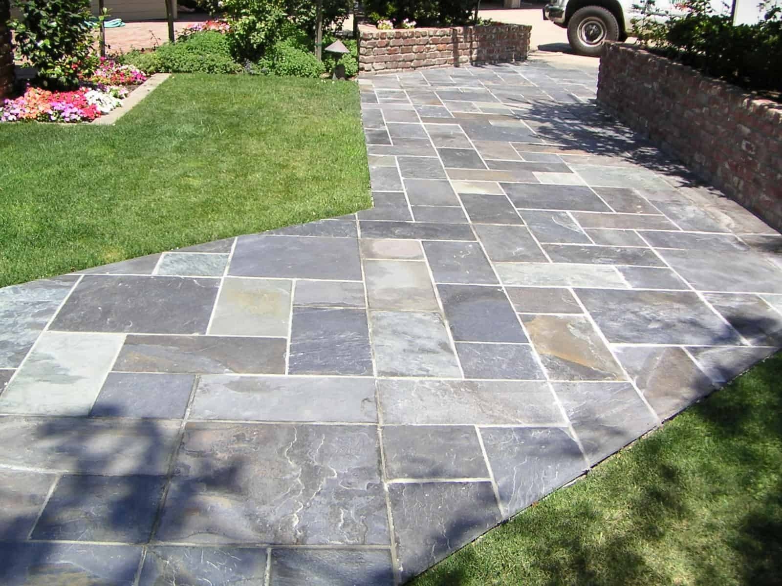 Flagstone path bordered by green lawn.