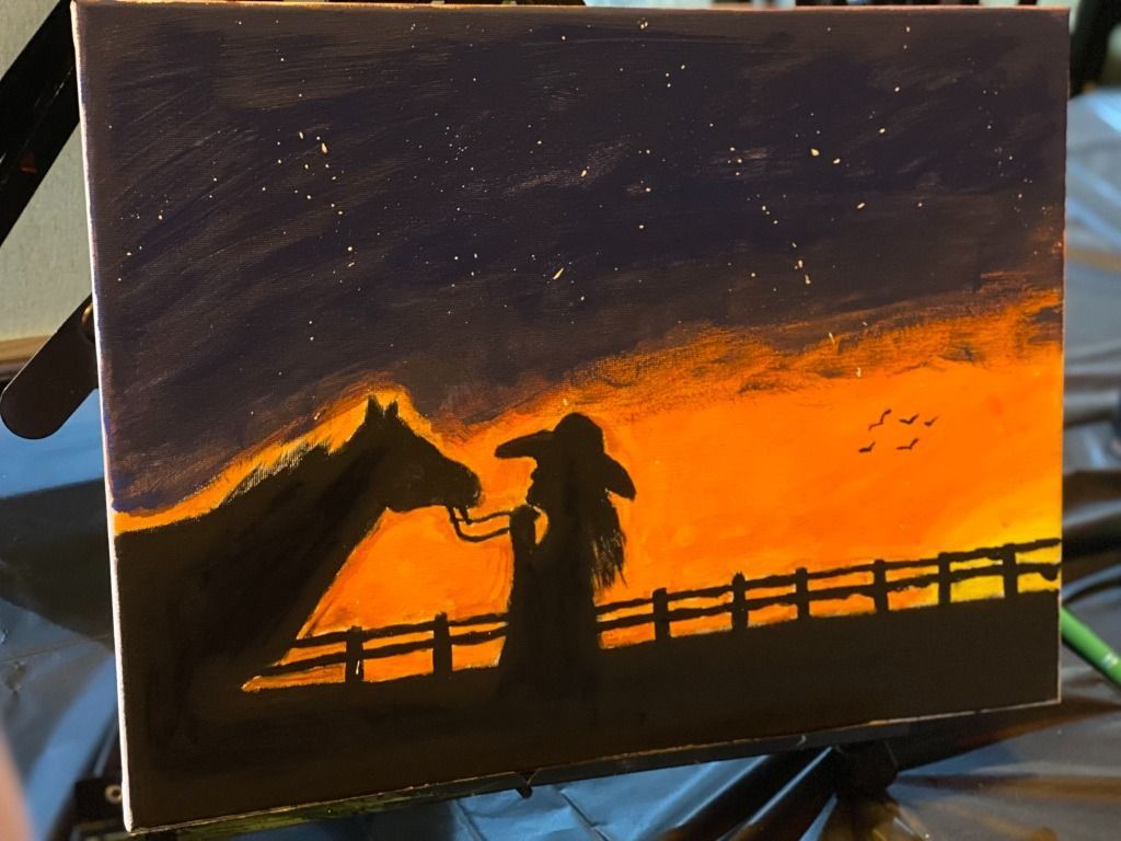 Silhouette of a person with a horse, on a hillside at sunset with stars.