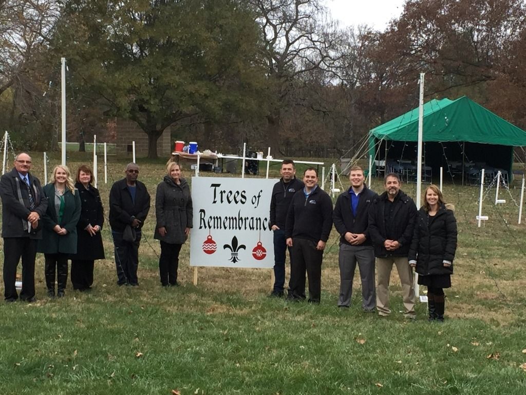 Group of people standing in a field next to a 