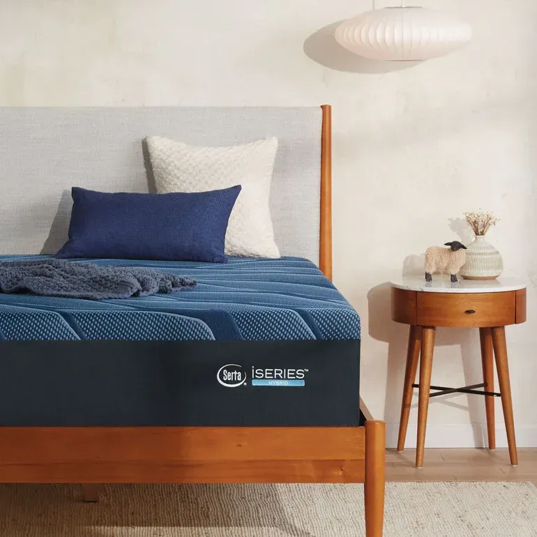 A bed with a blue mattress and pillows on it