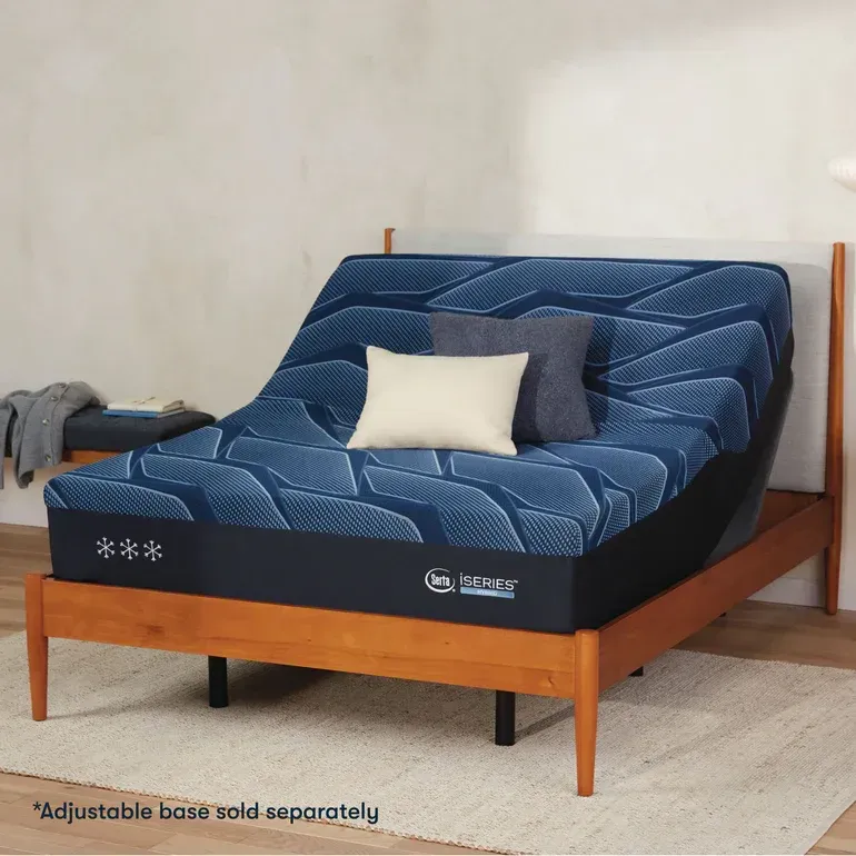 An adjustable bed with a blue mattress and pillows