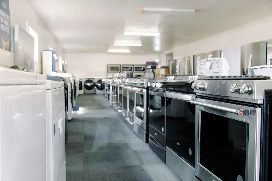 A row of appliances are lined up in a store.