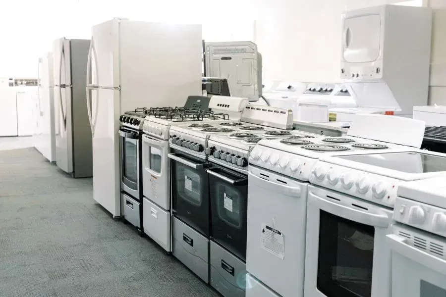 A kitchen with a lot of appliances including a refrigerator and stove