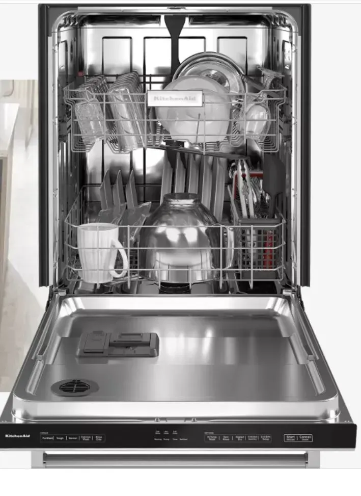 A dishwasher with its door open and filled with dishes and cups.