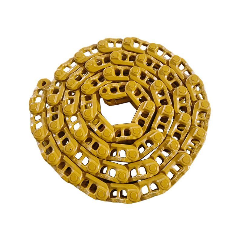Coiled gold-toned metal chain on a white background
