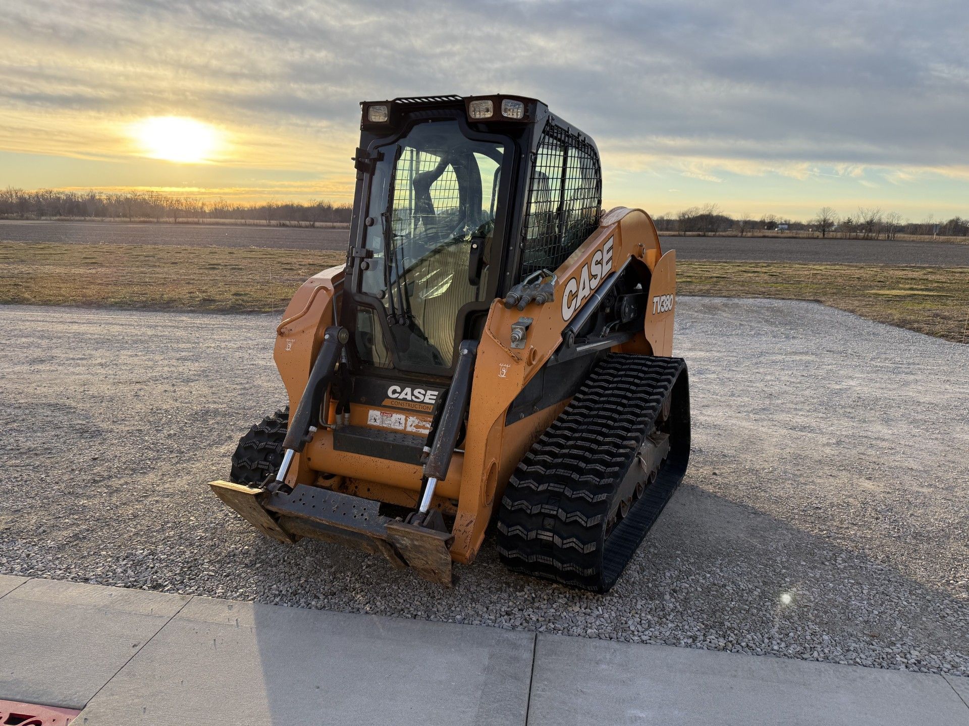 Yellow CAT skid steer with orange with rubber tracks