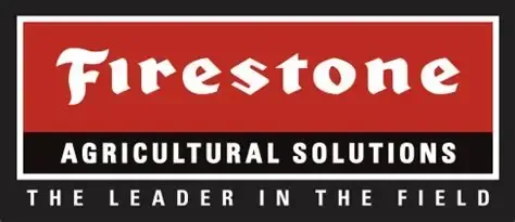 Firestone Agricultural Solutions logo with tagline “The Leader in the Field” on a red, black, and white sign