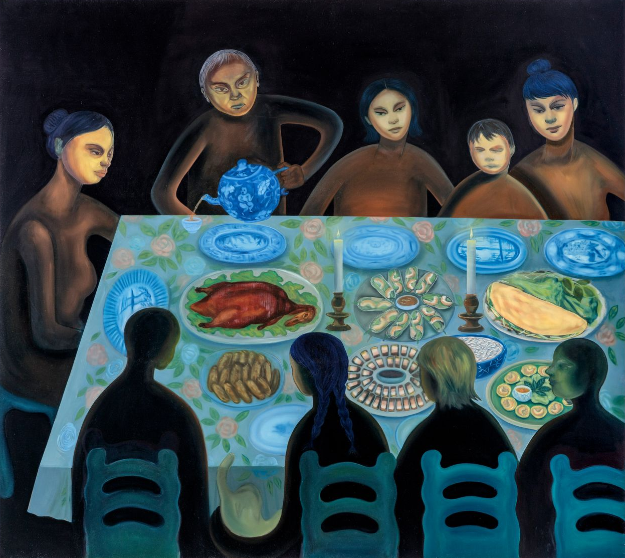 Family seated around a table laden with food. Figures in dark clothing, some gazing down, others above.