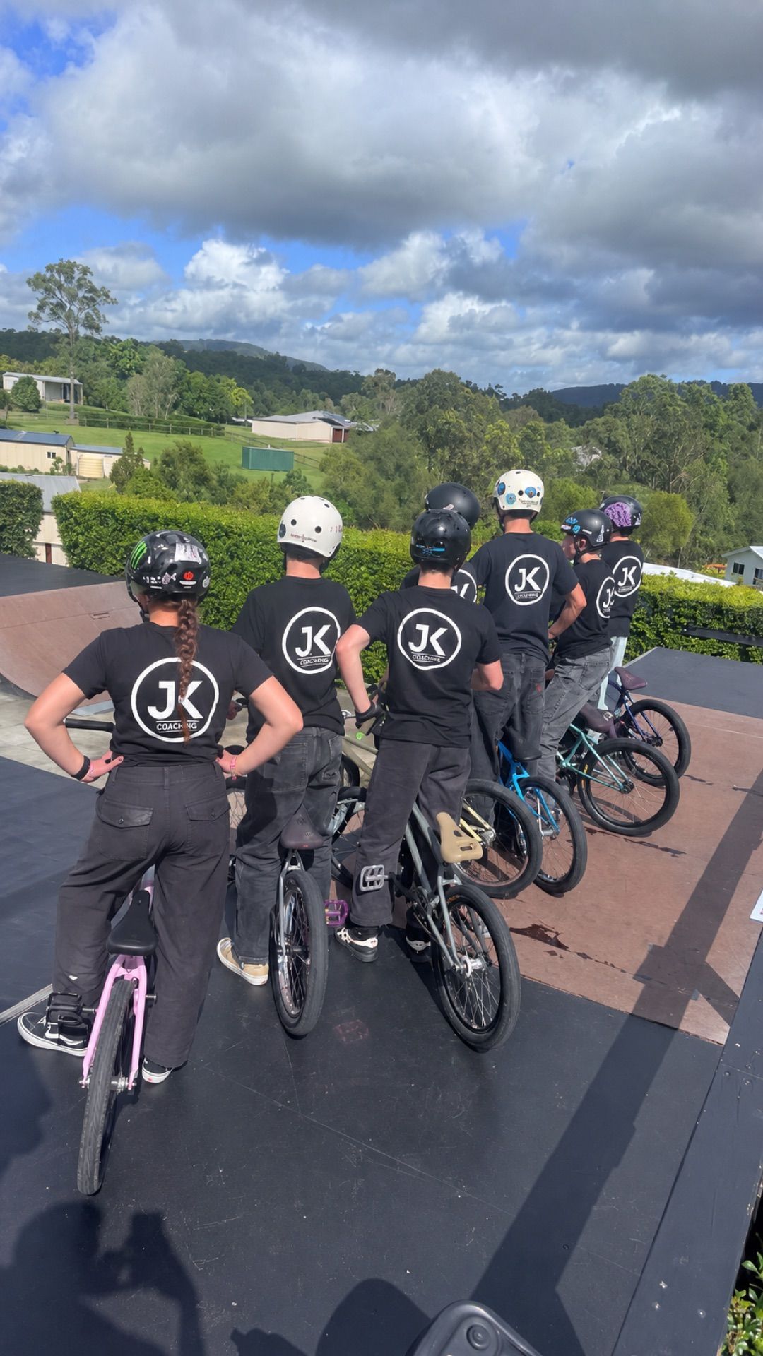 JKC crew lined up with their bikes on a ramp