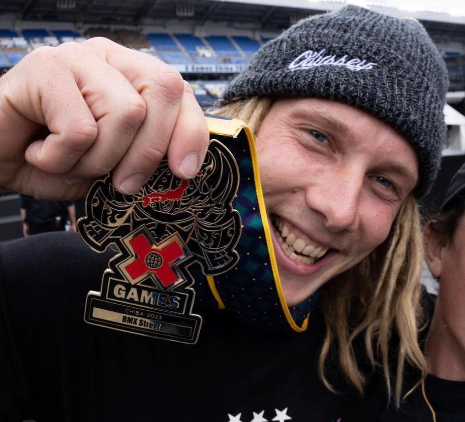 A man holding up a medal that says gamers on it