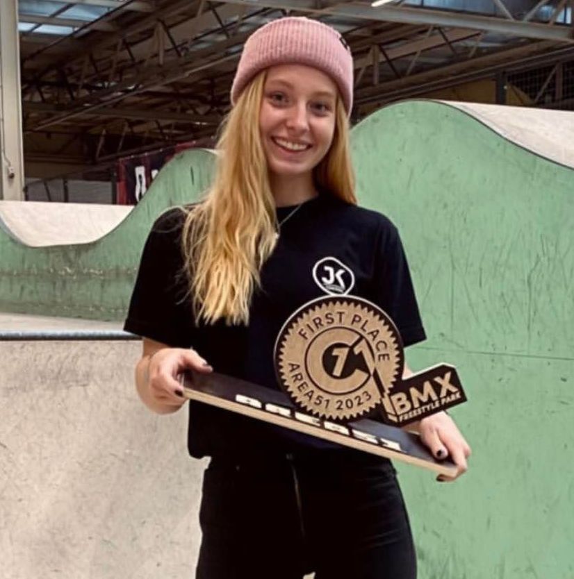 A girl wearing a black shirt that says first place