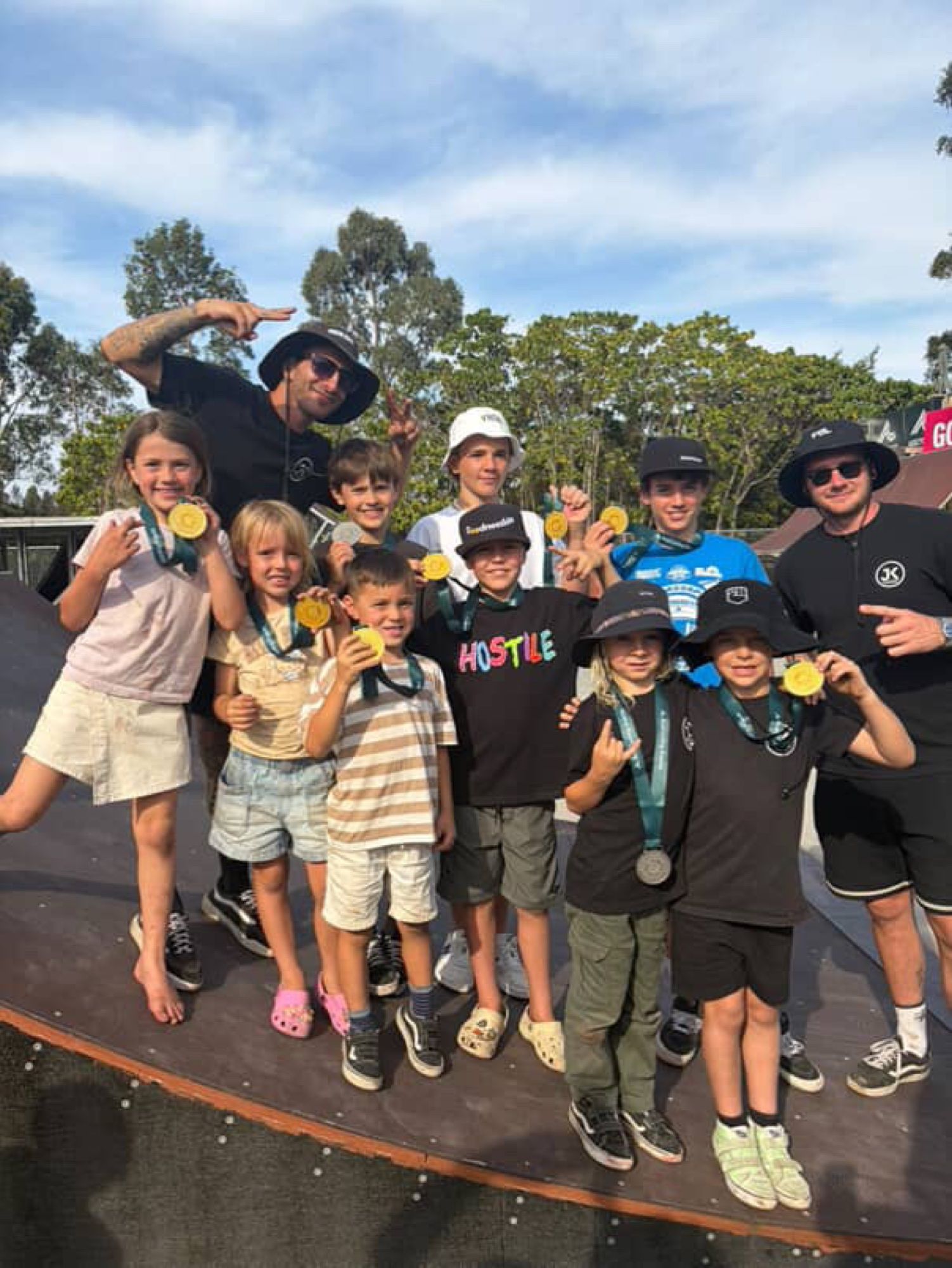 JKC riders and coaches celebrating medals after a BMX session